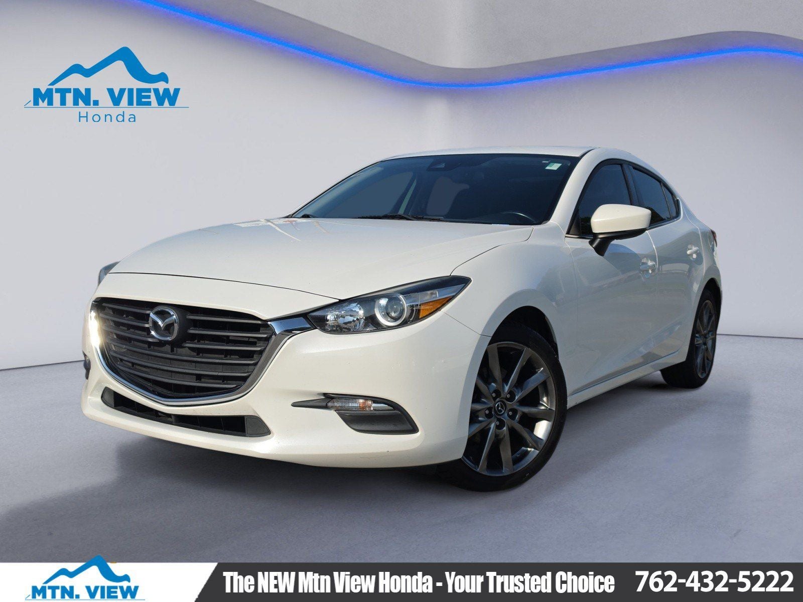 2018 Mazda Mazda3 Touring in Snowflake White Pearl Mica — front three-quarter view
